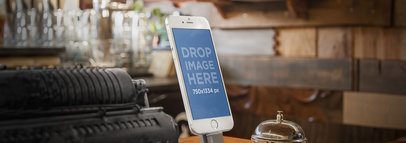 Wide Mockup of an iPhone 6 on a Stand at a Vintage Shop