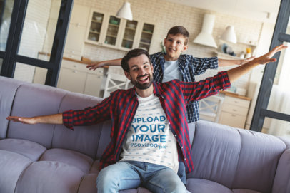 T-Shirt Mockup of a Dad and His Son Playing on the Couch