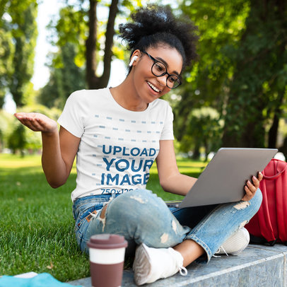 Tee Mockup of a Woman with Glasses Having a Video Conference on Her Laptop