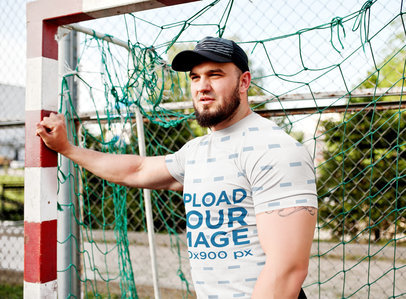 Mockup of a Muscular Man Wearing a T-Shirt in a Soccer Field