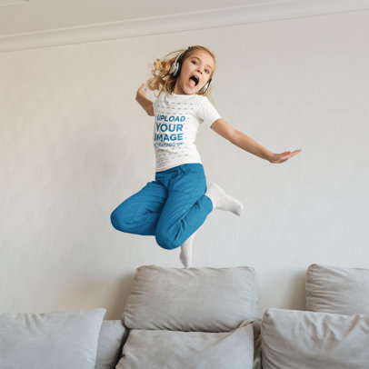 T-Shirt Mockup of a Happy Girl with Headphones Jumping over a Couch m18039-r-el2
