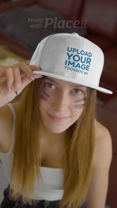 Video of a Woman Pointing at Her Snapback Hat While Watching the Big Game