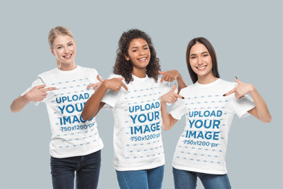 Mockup of Three Teenage Girls Pointing at Her T-Shirts in a Studio
