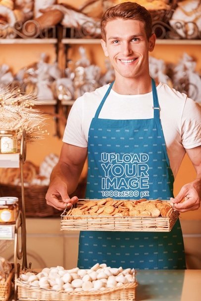 Mockup of a Man with a Tray of Cookies Wearing a Sublimated Apron