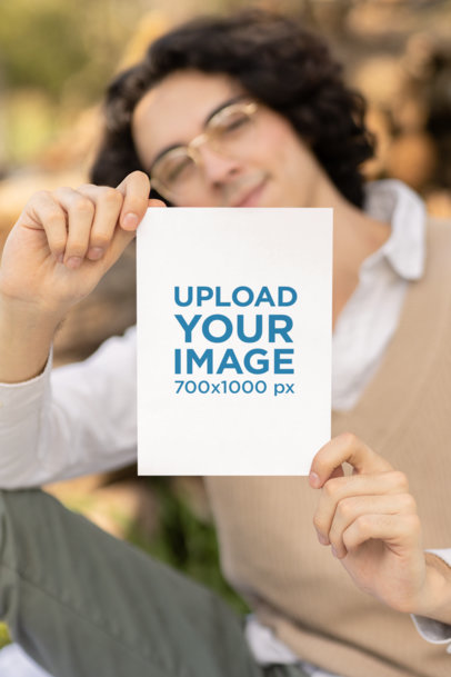 Mockup of a Smiling Man Showing a Vertical Flyer