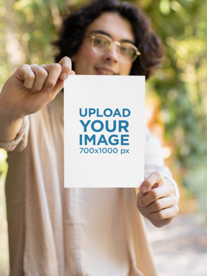 Mockup of a Man with Glasses Holding a Flyer with Both Hands M18747