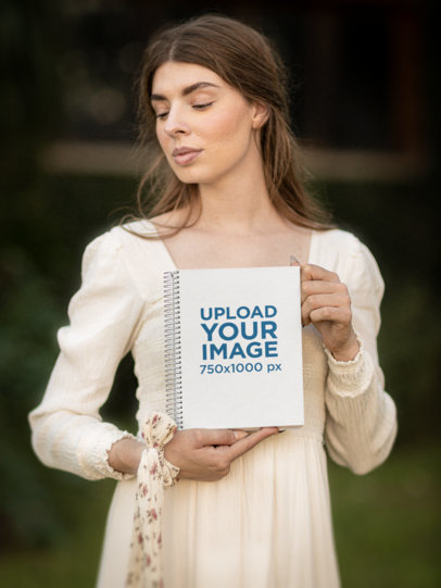 Notebook Mockup Featuring a Young Woman in a Cottagecore-Inspired Outfit m18744