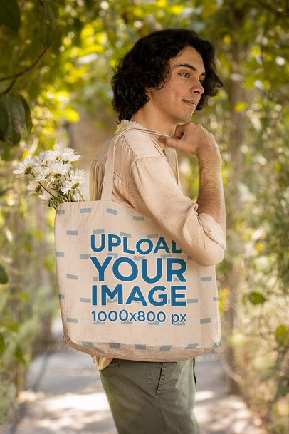 Cottagecore-Themed Mockup Featuring a Young Man Carrying a Tote Bag With Flowers m18724