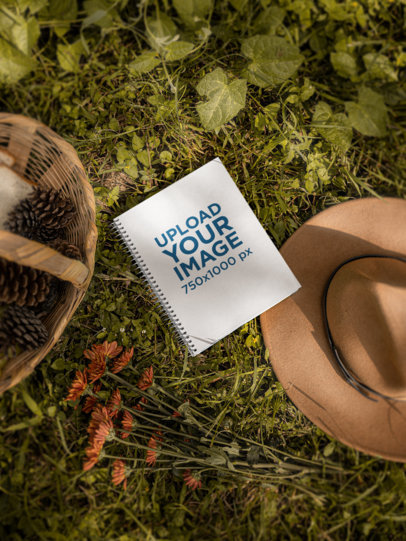 Cottagecore-Inspired Mockup of a Notebook Placed on Grass M18740