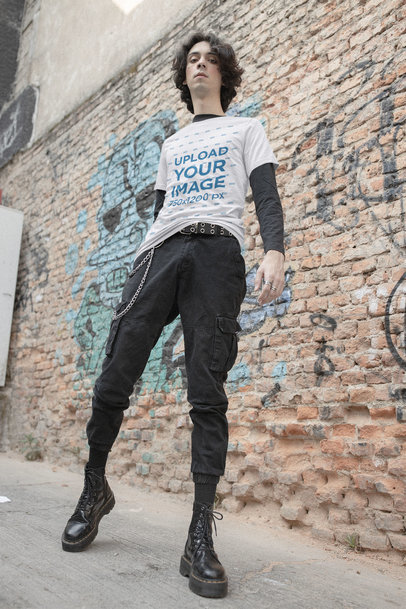 Bella Canvas T-Shirt Mockup Featuring an E-boy Posing by a Brick Wall