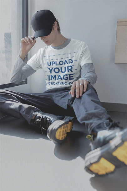 Round-Neck Tee Mockup of a Man with eBoy-Outfit Sitting at Home m19889