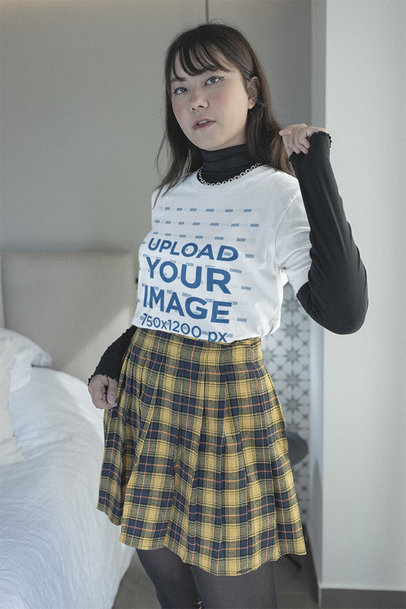 Mockup of an E-girl Wearing a Bella Canvas T-Shirt in Her Bedroom