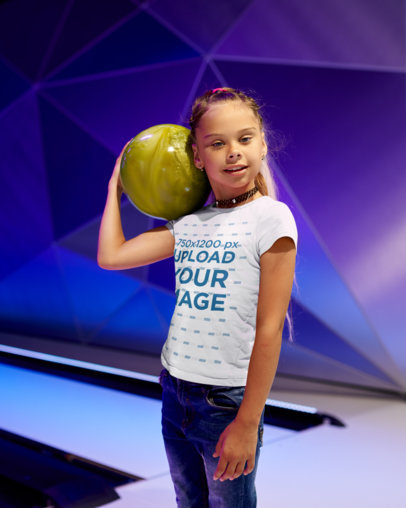 T-Shirt Mockup Featuring a Smiling Girl Playing Bowling