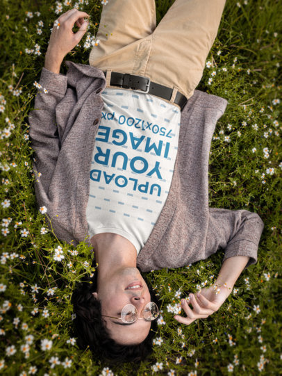 T-Shirt Mockup Featuring a Happy Man Lying on a Flower Field m18722