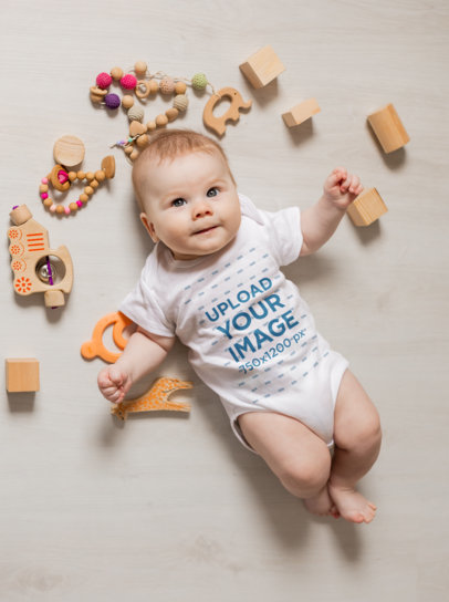 Onesie Mockup Featuring a Cute Baby Surrounded by Wooden Toys m19210-r-el2