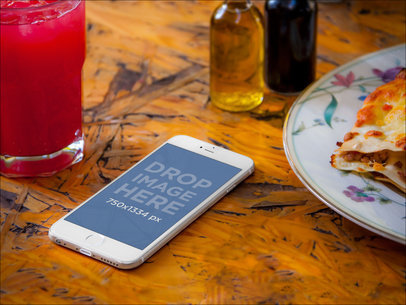 Mockup of a White iPhone 6 on a Restaurant Table
