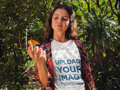 Woman Holding a Butterfly Wearing a Tshirt Mockup Near Plants