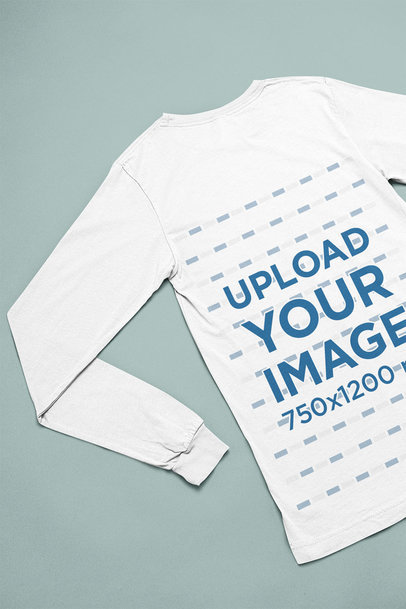 Back-View Mockup of a Bella Canvas Long Sleeve Tee Flat Laid over a Cardboard m13371