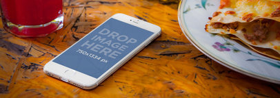 Wide Mockup of a White iPhone 6 on a Restaurant Table 
