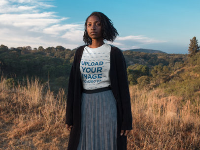 Mockup of a Woman Wearing a T-shirt While Outdoors on the Mountains