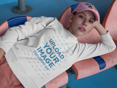 Girl Lying Down on Chairs at a Stadium Wearing a Crewneck Sweater Mockup a18411