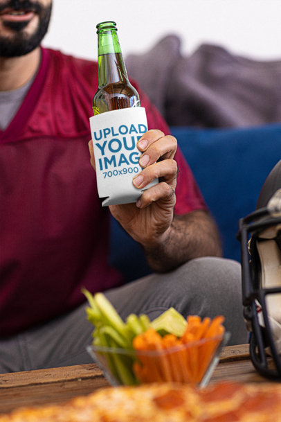 Koozie Mockup Featuring a Happy Bearded Man Watching the Big Game While Drinking a Beer