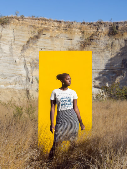 Mockup of a Woman Wearing a T-shirt and a Skirt Against a Yellow Paper Outdoors 