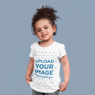 T-Shirt Mockup of a Cute Girl Posing at a Studio