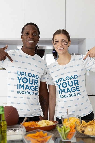 Mockup of a Two Football Fans Pointing at Their T-Shirts and Having Snacks m20399