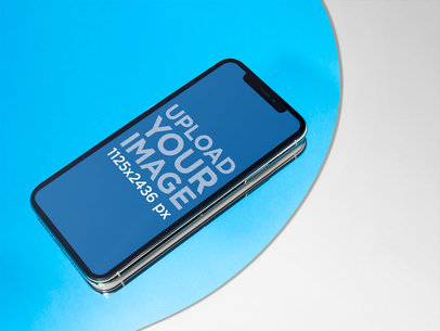 iPhone X Mockup Lying on a Light Blue Circle over a Solid Color Surface fa19111