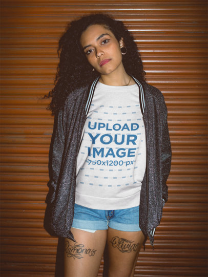Flash Nightshot of a Pretty Woman Wearing a Tshirt Mockup Against an Orange Metallic Curtain a18837