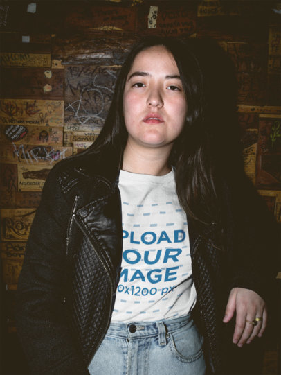Night Shot of an Asian Woman Wearing a T-Shirt Mockup Against a Wooden Wall