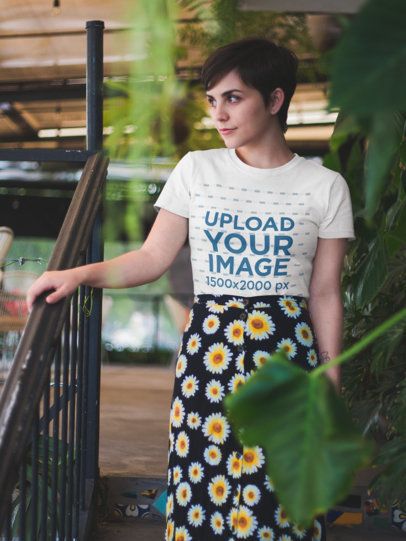 Short Haired Woman Wearing a T-Shirt Mockup while Going Down the Stairs