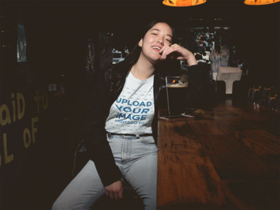Asian Woman Drinking a Beer Wearing a T-Shirt Mockup at the Bar