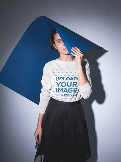 Pretty Woman Wearing a Crewneck Sweater Mockup Holding a Poster Board
