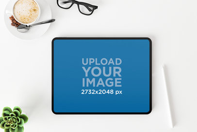 Mockup of an iPad Placed on a White Office Desk
