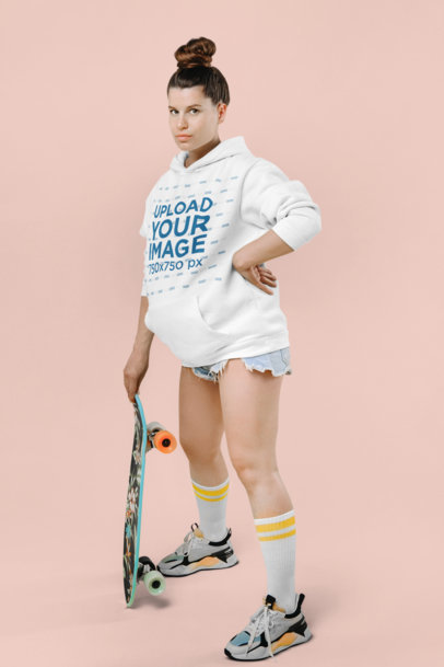 Hoodie Mockup of a Pregnant Woman Holding a Skateboard