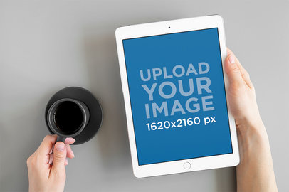 Digital Mockup Featuring a Pair of Hands Holding an iPad and a Cup of Coffee