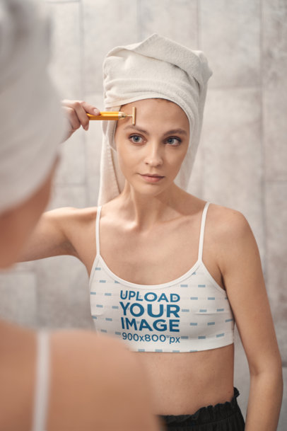 Sports Bra Mockup Featuring a Woman Doing Her Skincare Routine m11873 r-el2