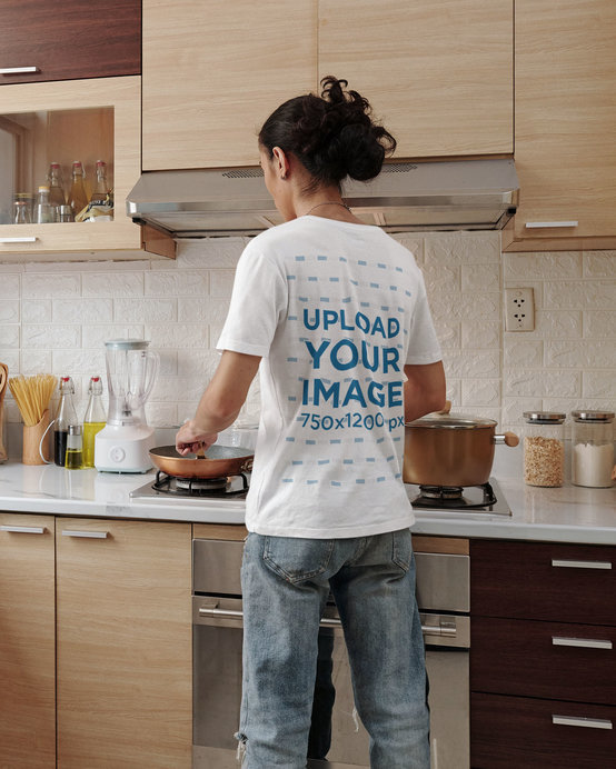 T-Shirt Mockup Featuring a Long-Haired Man Cooking
