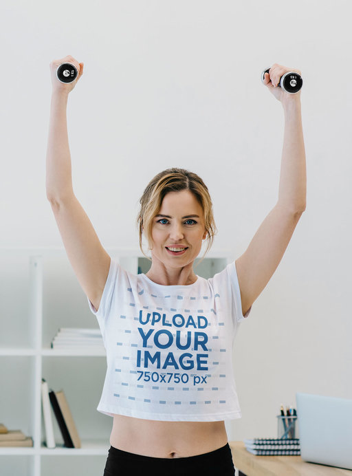Crop Top Mockup of a Woman Exercising with a Pair of Dumbbells at the Office