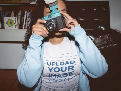 Woman Taking a Photo at Night Wearing a T-Shirt Mockup in her Room