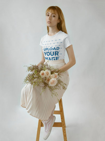 Girl Wearing a Round Neck T-Shirt Mockup while Holding Flowers on her Lap a18362