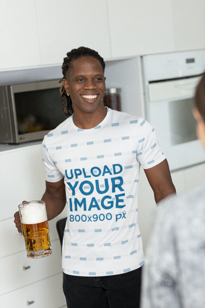 Jersey Mockup of a Smiling Man Holding a Beer in the Kitchen