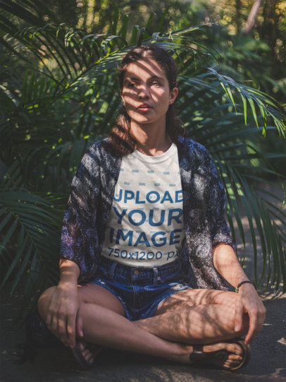 White Woman Sitting Down Near Plants Wearing a T-Shirt Mockup