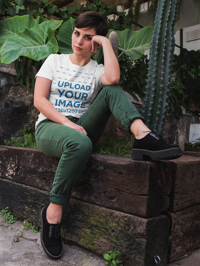 Mockup of a Woman Relaxing Near Cactus and Plants Wearing a T-Shirt