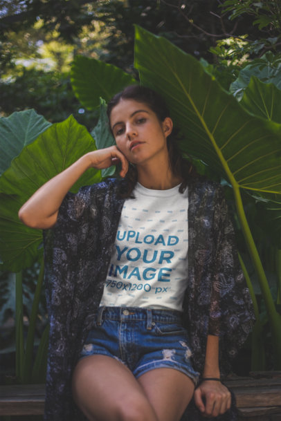 Portrait of a Woman Wearing a T-Shirt Mockup while Near Plants