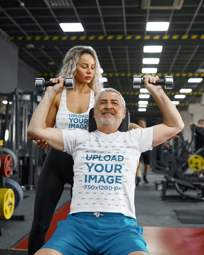 Sports Bra and T-Shirt Mockup Featuring a Senior Man and a Female Trainer at the Gym