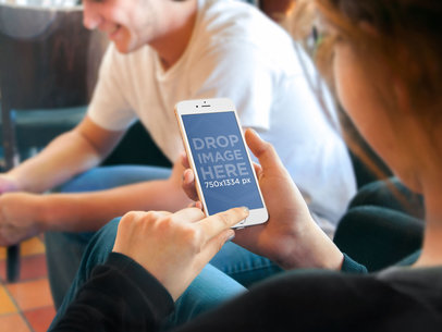 Mockup of a Woman Holding up an iPhone 6