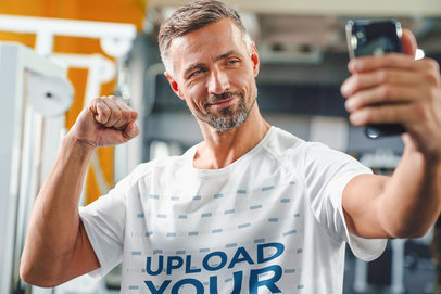T-Shirt Mockup of a Middle-Aged Man Taking a Selfie at the Gym